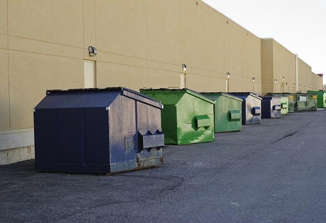 a row of heavy-duty dumpsters ready for use at a construction project in Colts Neck, NJ